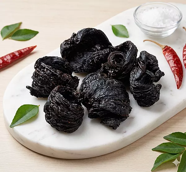 Close-up of sun-dried de-seeded kudampuli showing natural Malabar tamarind texture